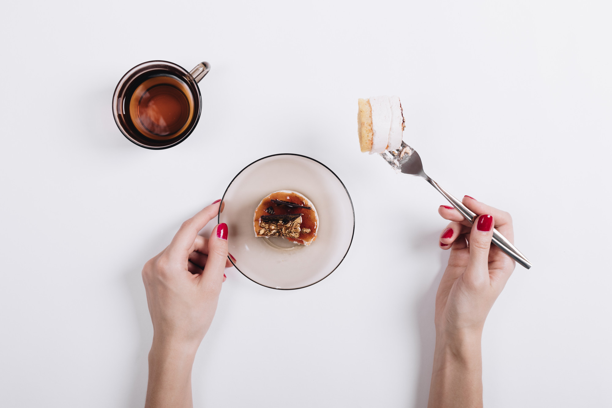 Close-up of hands plating a dessert
