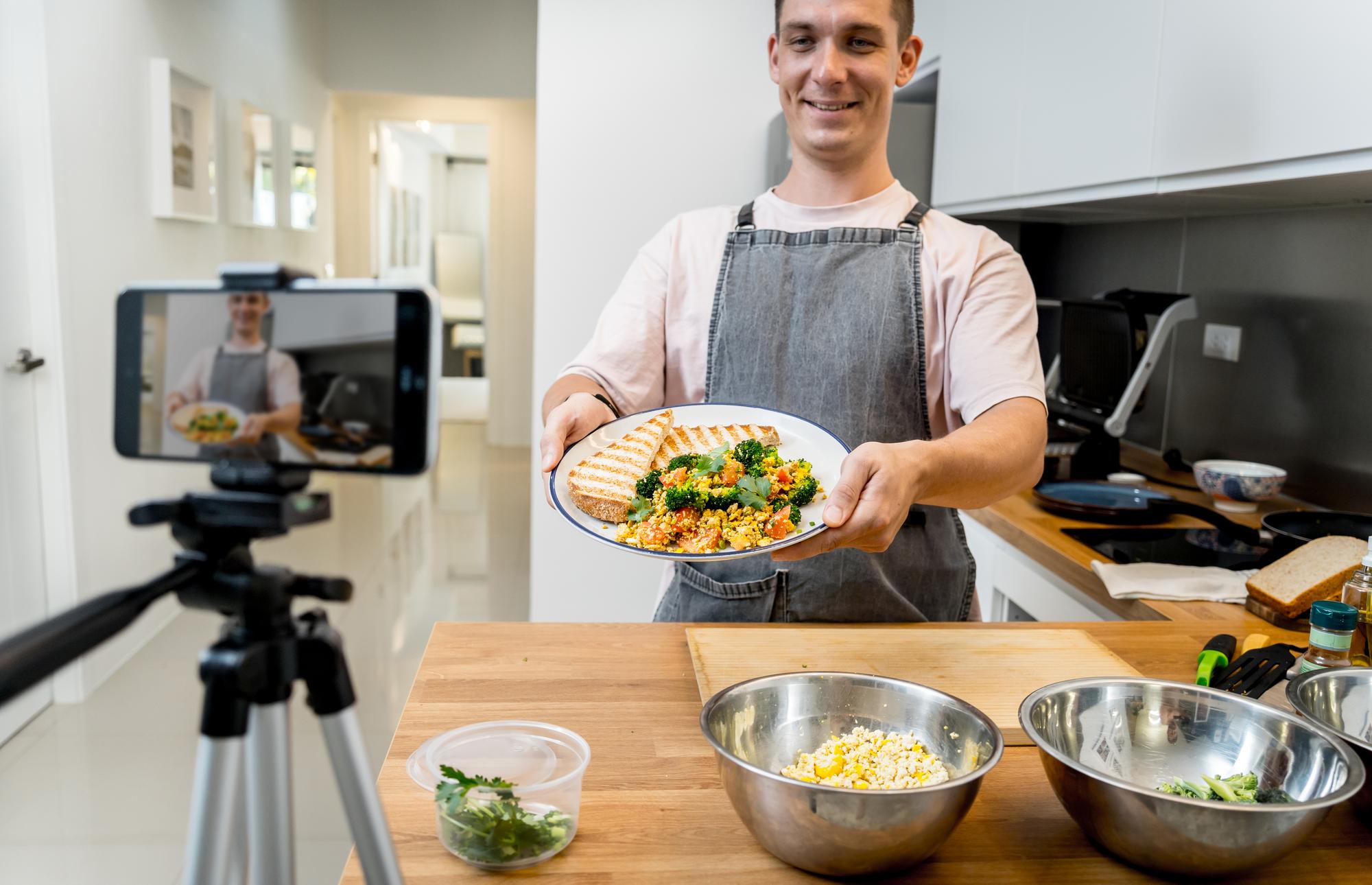Chef demonstrating a plated dish on a video call