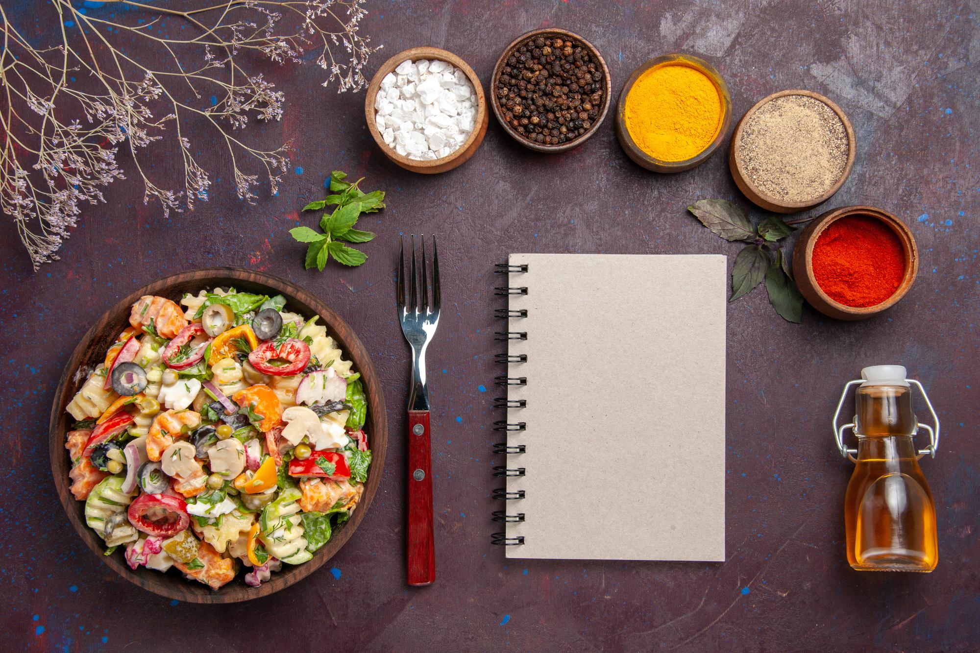 Compact overhead of plated dishes and notebook